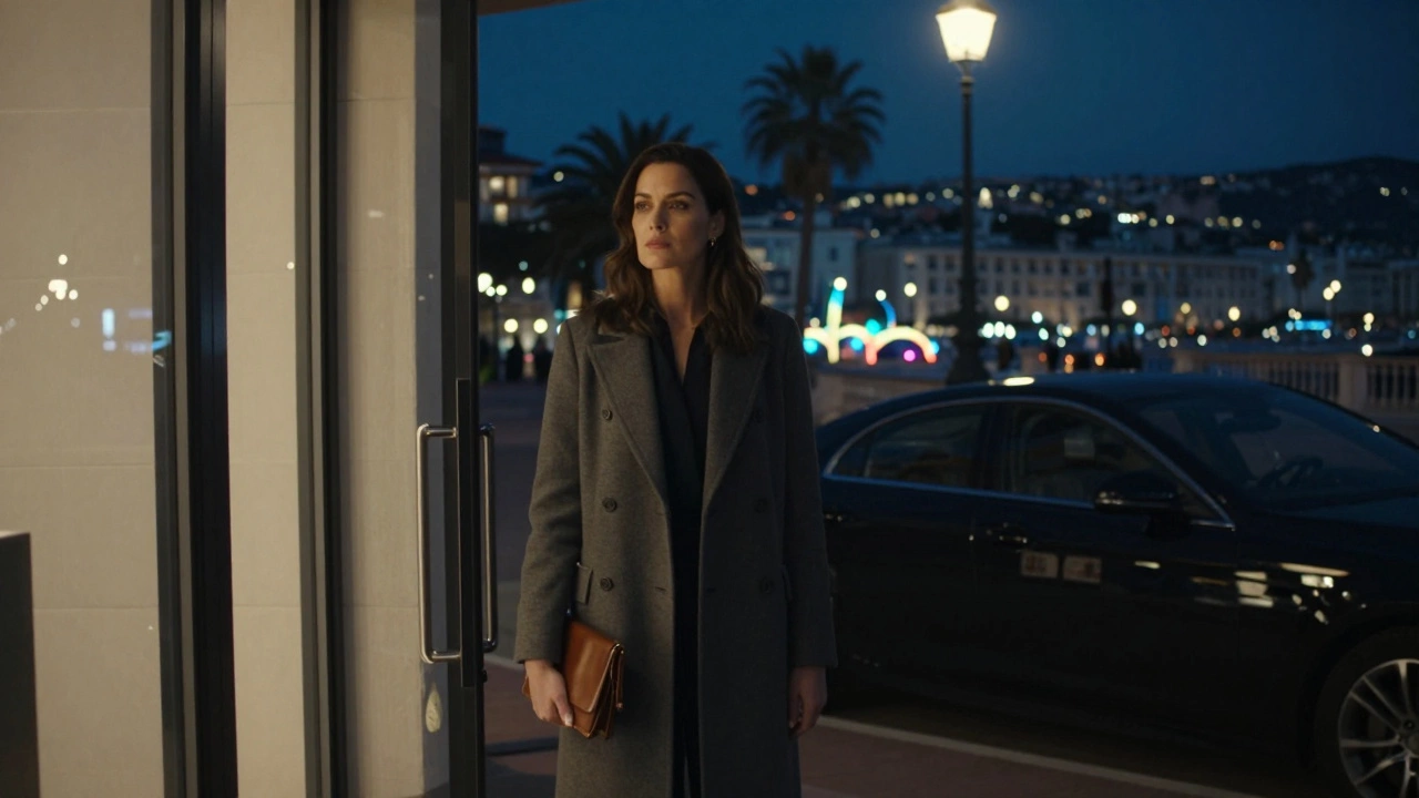 A professional woman waiting discreetly outside a high-end hotel in Cannes at night.